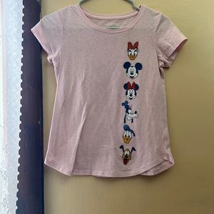 I am selling a pink Shirt that has Mickey Mouse characters on it.